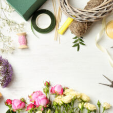 Florist,equipment,with,flowers,on,wooden,background,,top,view