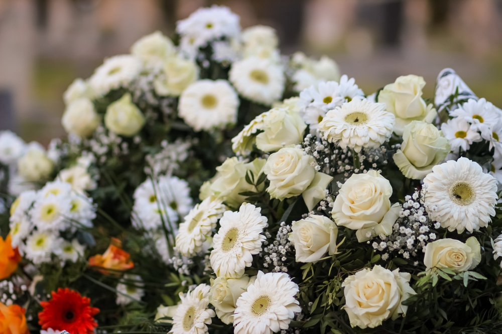 Funeral,wreaths,made,from,white,roses,and,gerberas,,winter,cemetery.