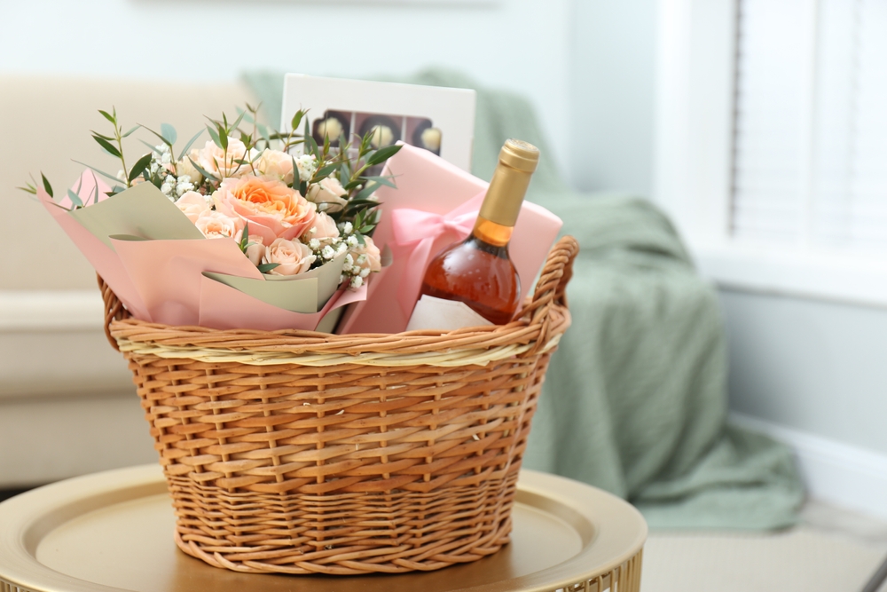 Wicker,basket,with,gifts,on,table,indoors
