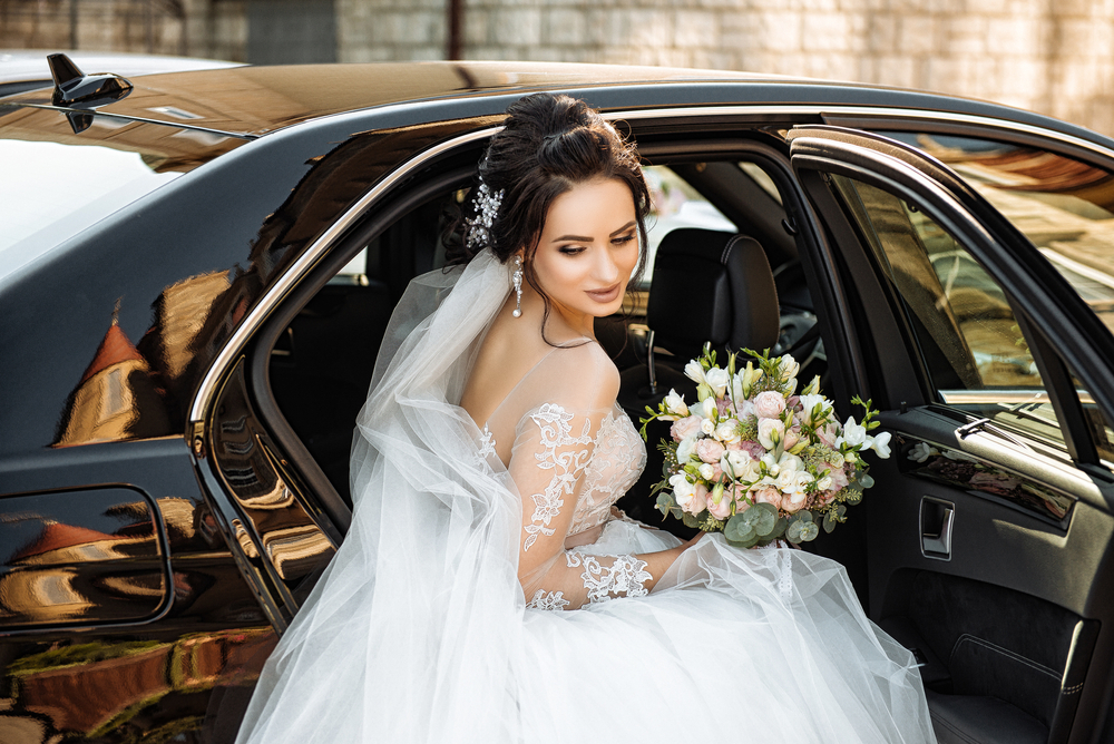 Dark Haired,bride,jewelry,head,sits,in,a,black,car,on